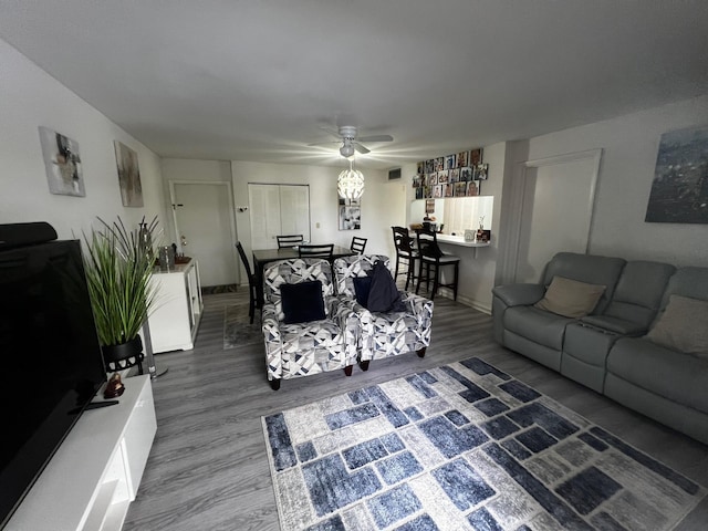 living room with wood-type flooring and ceiling fan