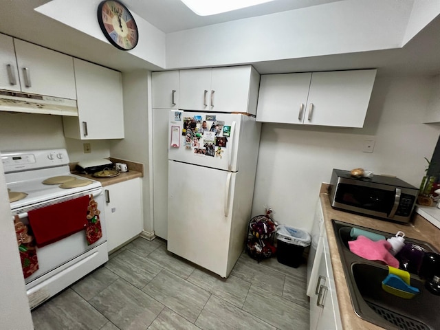 kitchen with white cabinets, white appliances, and sink