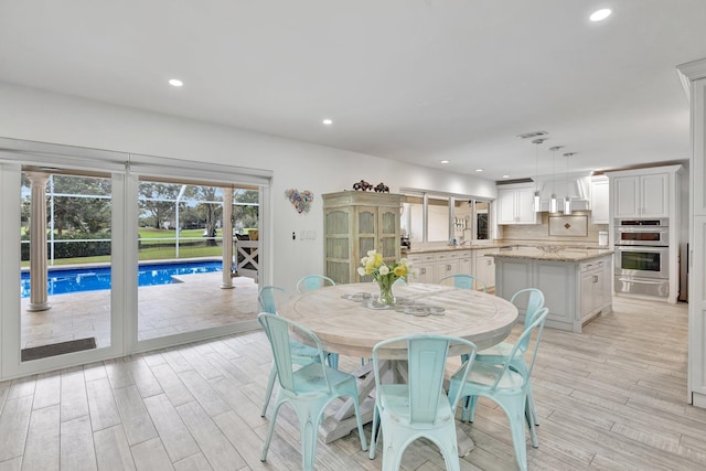 dining space featuring light hardwood / wood-style floors and sink