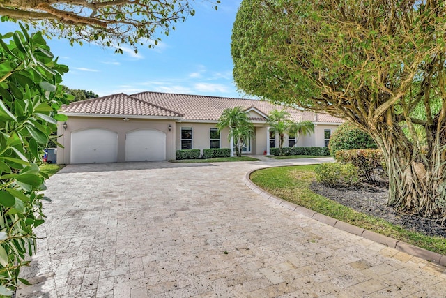 9010 S Lake Dasha Dr, Plantation, FL 33324 - view of front of house featuring a tiled roof, stucco siding, decorative driveway, and an attached garage