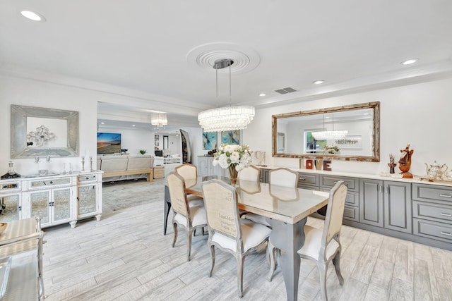 9010 S Lake Dasha Dr, Plantation, FL 33324 - dining space featuring light wood-style floors, a chandelier, recessed lighting, and crown molding
