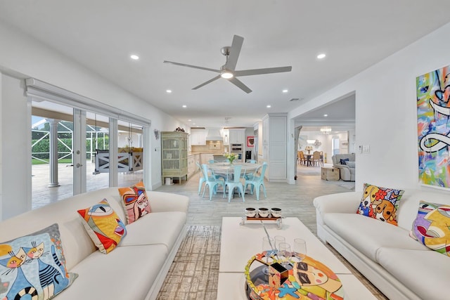 living room featuring ceiling fan, french doors, and light hardwood / wood-style floors