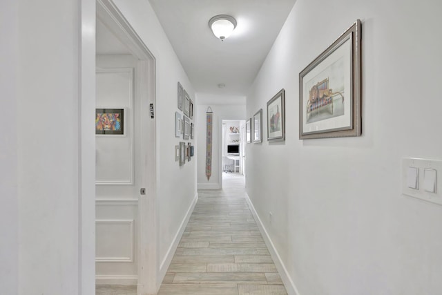 hall with light wood-type flooring