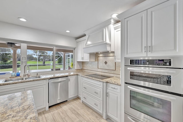 9010 S Lake Dasha Dr, Plantation, FL 33324 - kitchen with appliances with stainless steel finishes, a sink, white cabinetry, custom range hood, and decorative backsplash