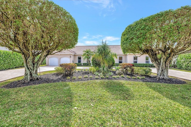 view of front of house with a garage and a front yard