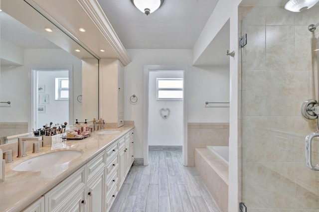 bathroom featuring separate shower and tub and vanity