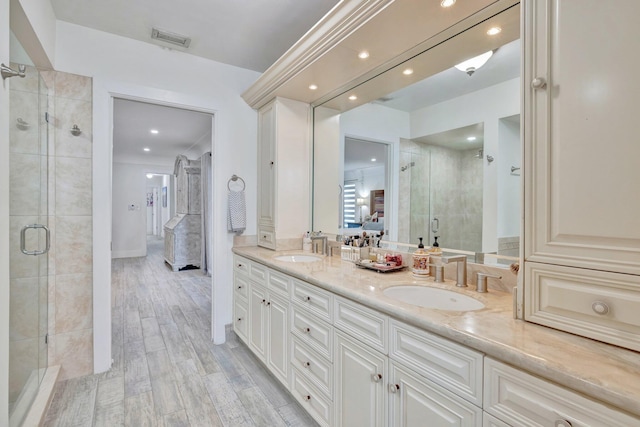 9010 S Lake Dasha Dr, Plantation, FL 33324 - ensuite bathroom with a stall shower, double vanity, wood finished floors, and recessed lighting