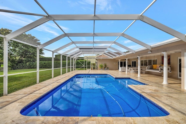 view of swimming pool with a lawn, ceiling fan, a lanai, an outdoor living space, and a patio area