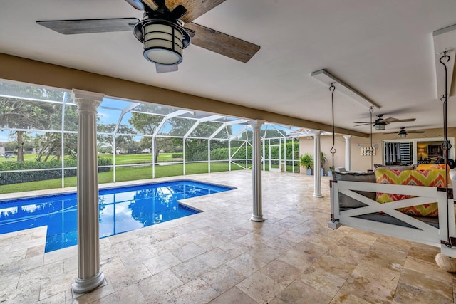 view of pool featuring glass enclosure and a patio