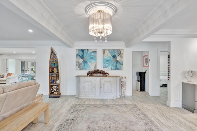 living room featuring a notable chandelier, light wood-type flooring, and crown molding