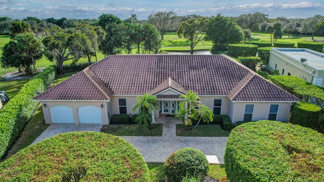 9010 S Lake Dasha Dr, Plantation, FL 33324 - view of front of property with a tiled roof, stucco siding, a garage, and driveway