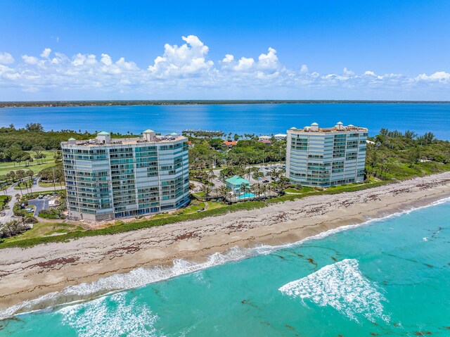 birds eye view of property with a view of the beach and a water view