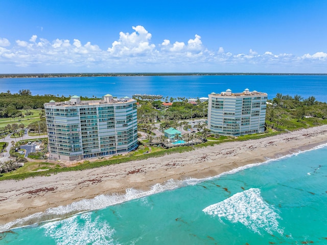 aerial view with a water view and a beach view