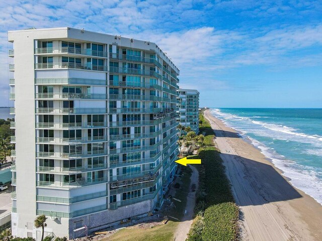 view of building exterior featuring a view of the beach and a water view