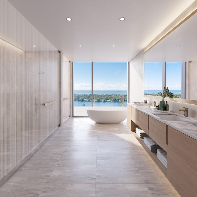 bathroom featuring a water view, a wealth of natural light, a washtub, and vanity