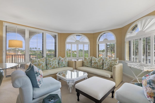 living area with carpet floors, a wealth of natural light, and ornamental molding