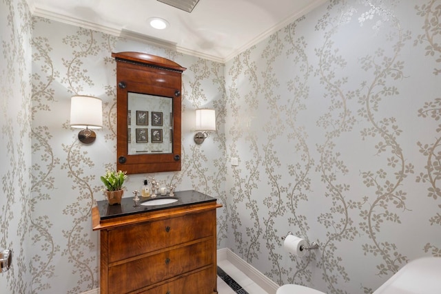 half bath with vanity, crown molding, and wallpapered walls