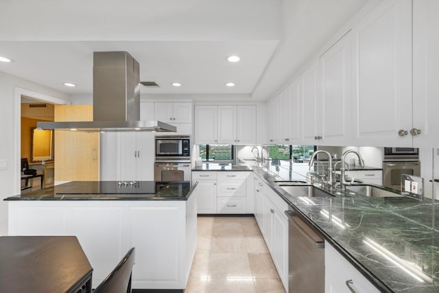 kitchen with island range hood, appliances with stainless steel finishes, white cabinetry, and sink