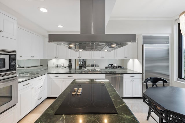 kitchen with sink, light tile floors, island exhaust hood, white cabinets, and black appliances