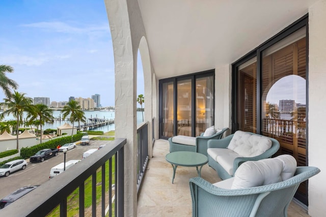 balcony featuring a water view and a view of city