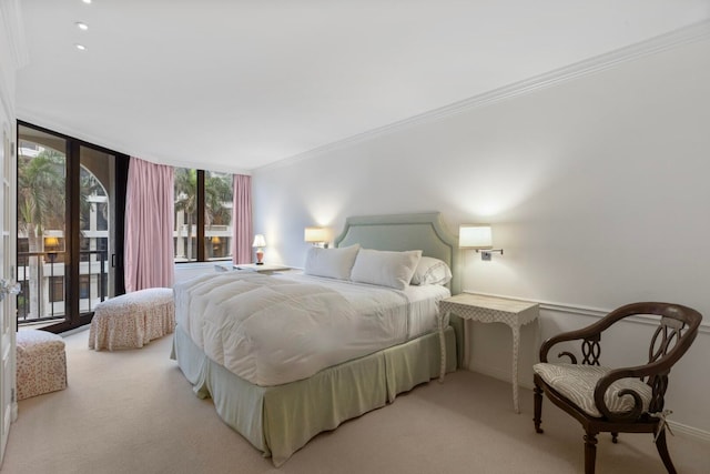 carpeted bedroom featuring a wall of windows, crown molding, access to outside, and baseboards