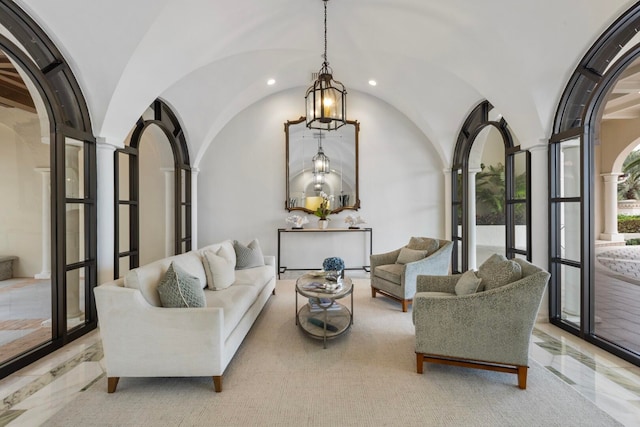 living room with arched walkways, recessed lighting, ornate columns, and vaulted ceiling