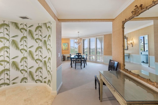 interior space with crown molding, an inviting chandelier, and light colored carpet