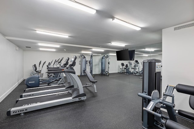 gym featuring baseboards and visible vents