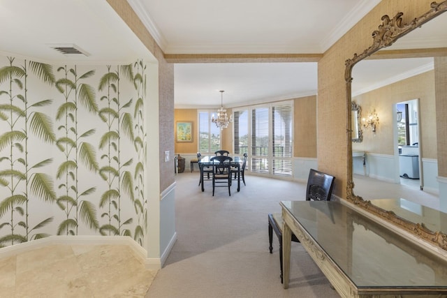 interior space with a chandelier, visible vents, wainscoting, and crown molding