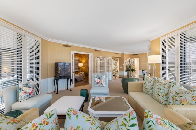 living area with crown molding and visible vents