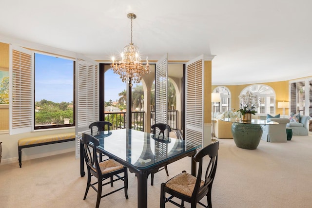 carpeted dining room featuring a notable chandelier, a healthy amount of sunlight, and baseboards