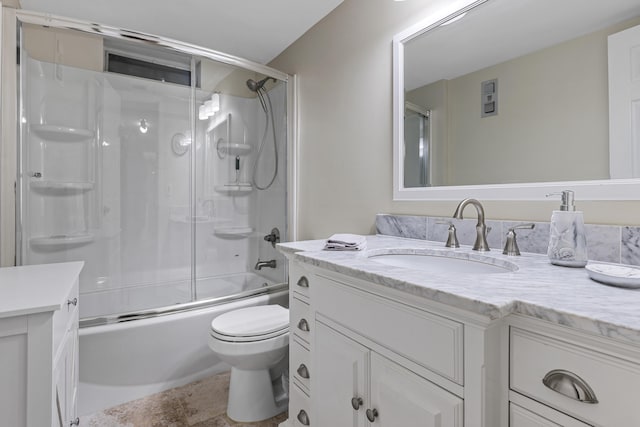 full bathroom with vanity, shower / bath combination with glass door, and toilet