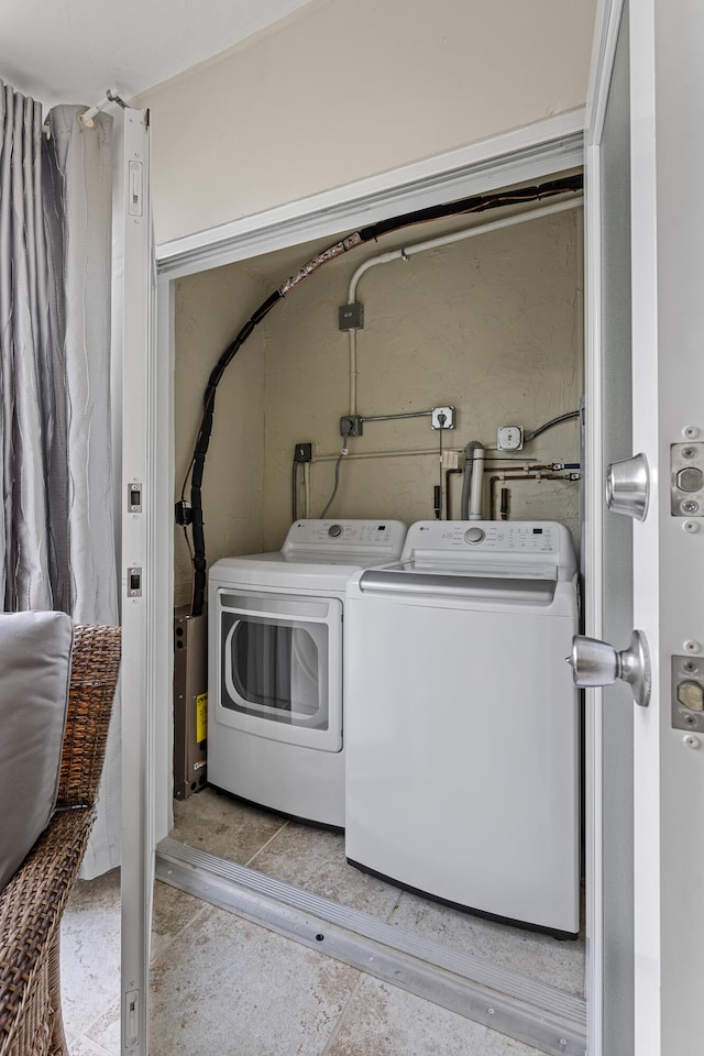 clothes washing area featuring independent washer and dryer