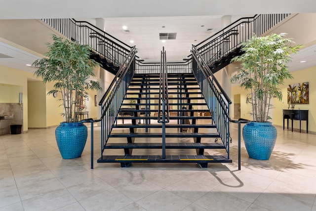 staircase featuring tile patterned floors