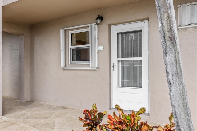 view of exterior entry featuring a patio area