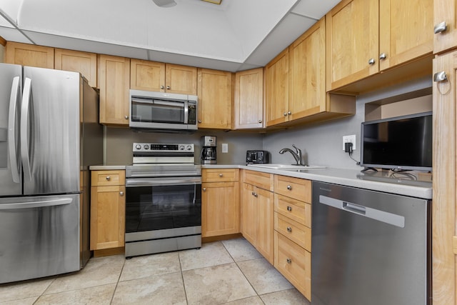 kitchen featuring sink, light brown cabinetry, appliances with stainless steel finishes, and light tile patterned flooring