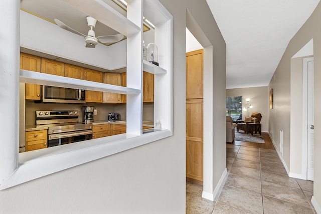 kitchen featuring ceiling fan and appliances with stainless steel finishes