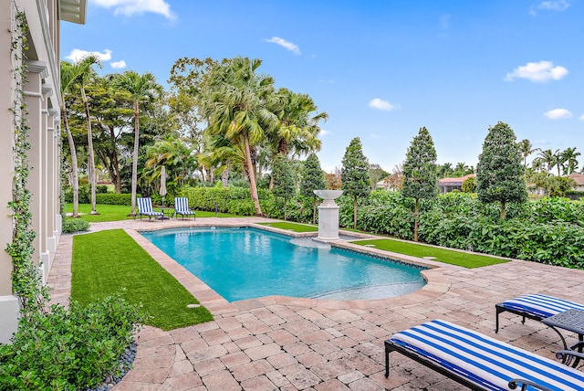 view of swimming pool featuring a lawn and a patio area