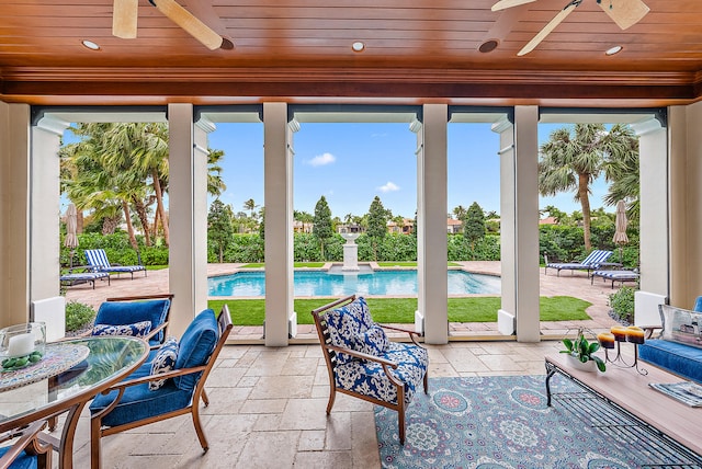 sunroom / solarium with wooden ceiling and ceiling fan