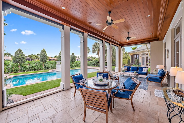 sunroom / solarium with wood ceiling and ceiling fan