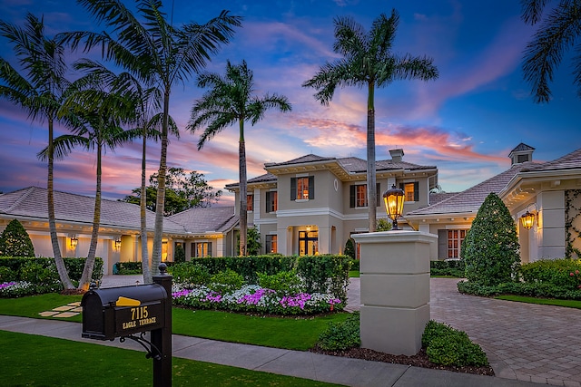 mediterranean / spanish-style house with a lawn