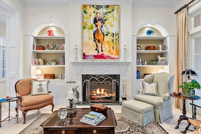 sitting room featuring ornamental molding, a fireplace, and built in shelves