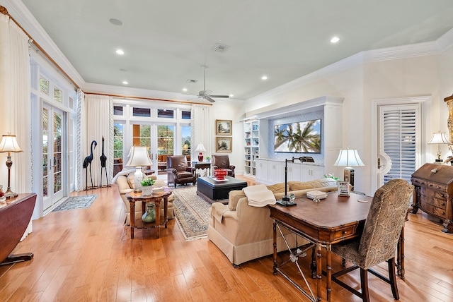 living room with french doors, ceiling fan, light wood-type flooring, and crown molding