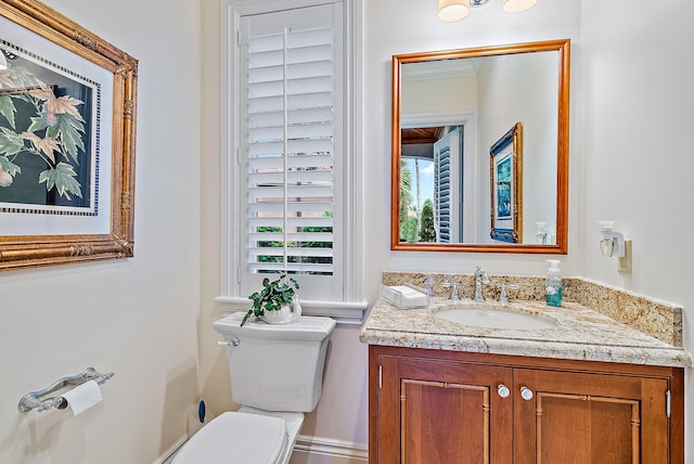 bathroom featuring toilet and vanity