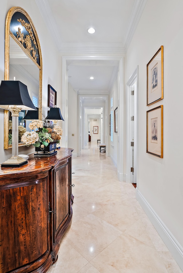 hall featuring light tile flooring and ornamental molding