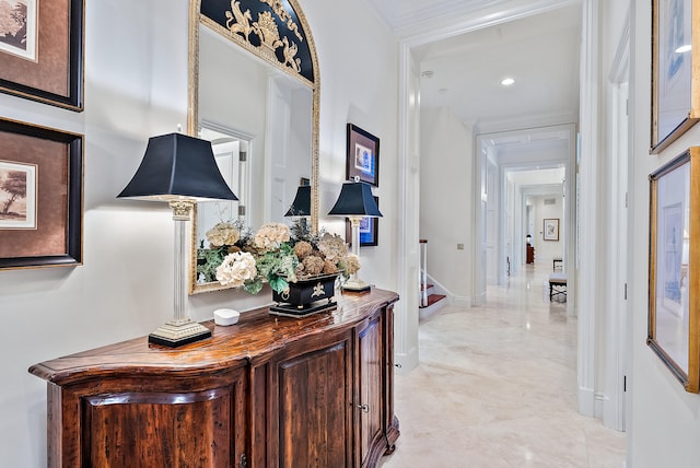 hall featuring light tile floors and crown molding