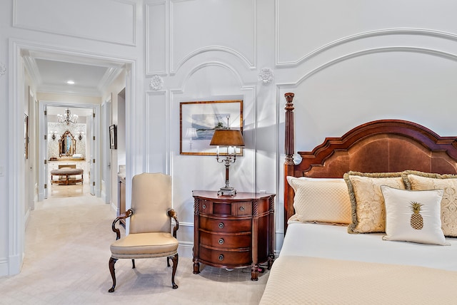 carpeted bedroom featuring a chandelier and crown molding