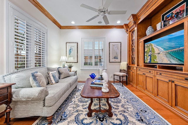 living room featuring light hardwood / wood-style floors, ceiling fan, and a wealth of natural light