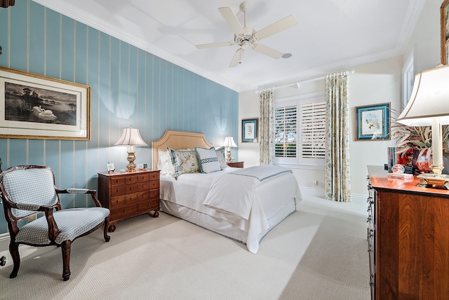 carpeted bedroom with crown molding and ceiling fan