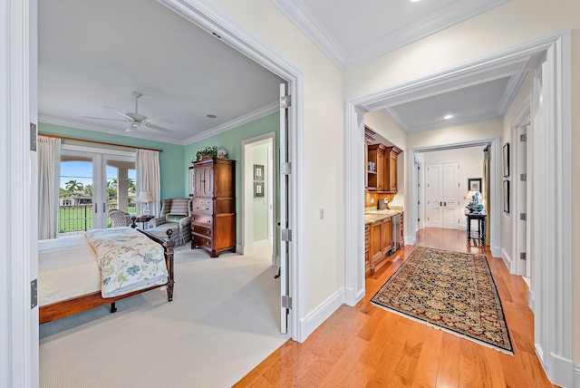 interior space with crown molding, french doors, and light wood-type flooring